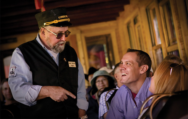 Conductor talking with passengers on the train