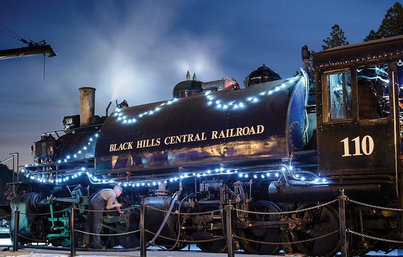 Night scene of train decorated with holiday lights