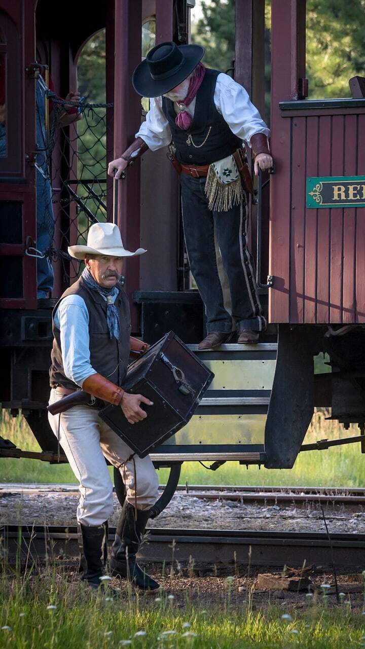 A couple cowboys come out of the 1880 Train during the wild west shoot out. 