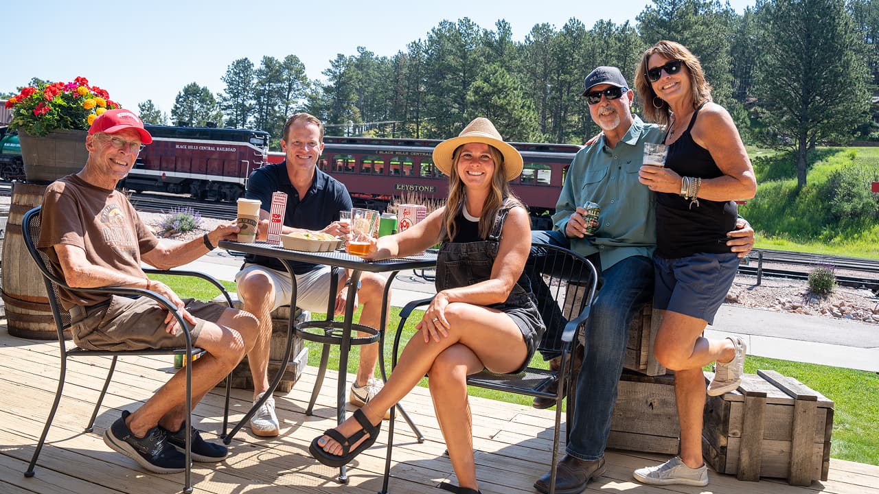 A group at the Eatery is enjoying food and drinks before they enjoy the train.