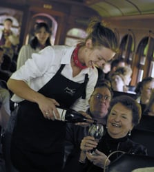 wine being poured into a glass for a wine express train rider on the 1880 Train