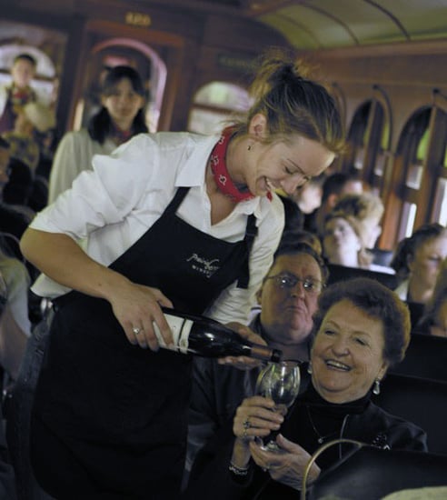 wine being poured into a glass for a wine express train rider on the 1880 Train